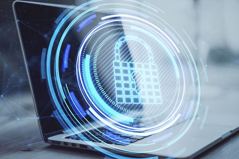 close-up-of-laptop-computer-on-desktop-with-creative-glowing-blue-padlock-hologram-on-blurry-b...jpg