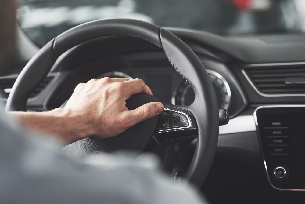 man-s-big-hands-on-a-steering-wheel-while-driving-a-car.jpg